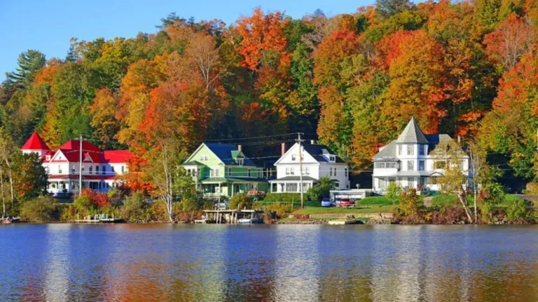 Aerial view of Hammondsport, New York with church steeple, fall foliage, and Keuka Lake in the background